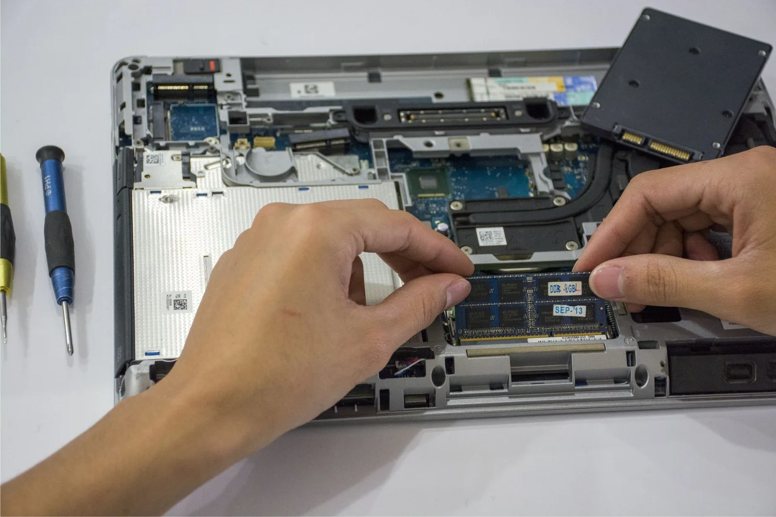 Technician servicing the internal components of a business laptop