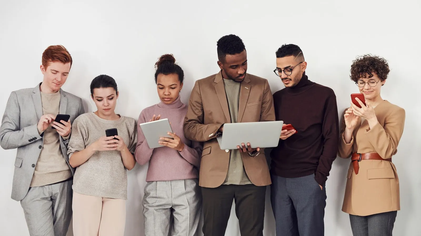 Colleagues working on their smartphones and a tablet