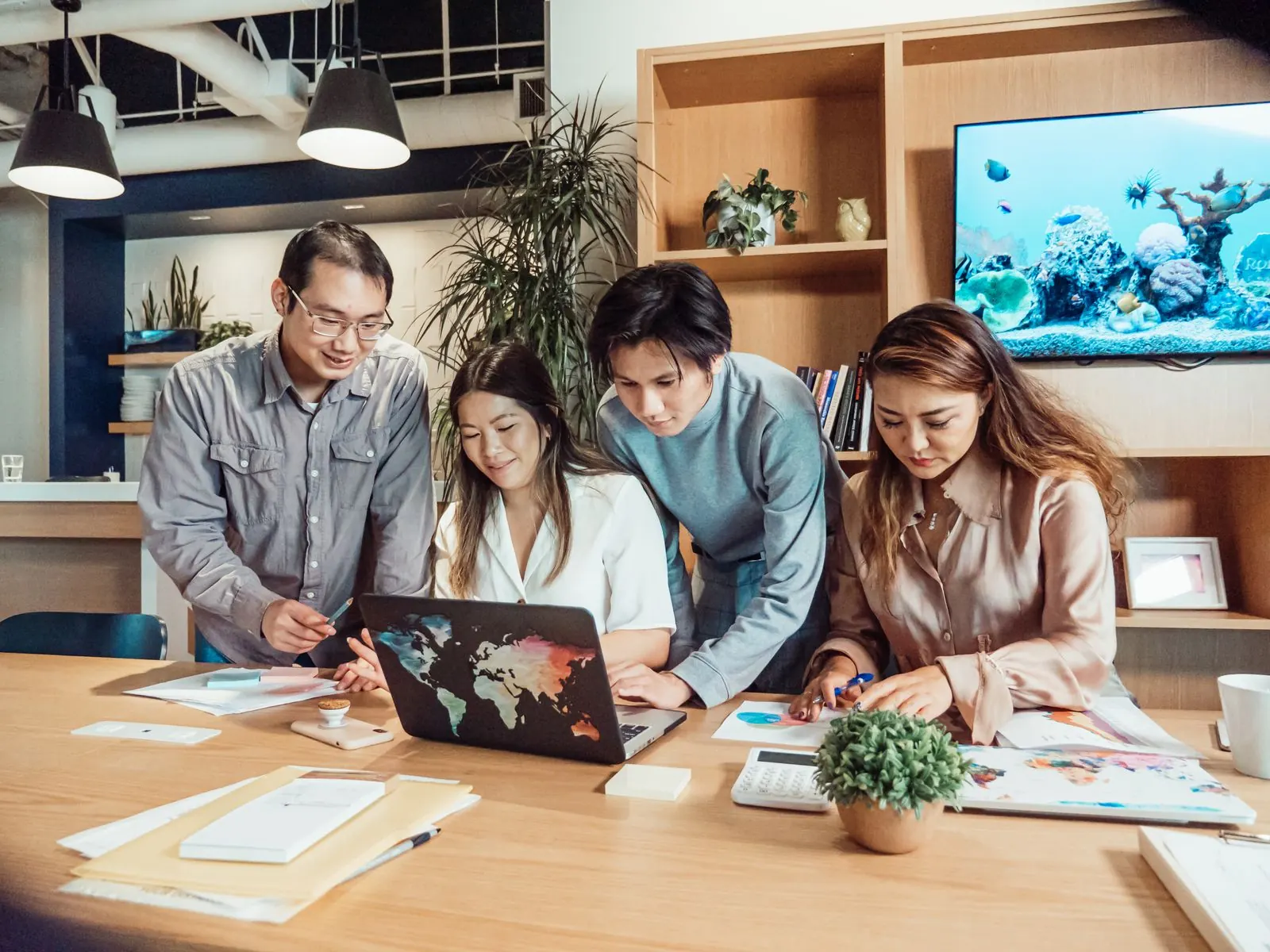 A team reviewing information together on a laptop